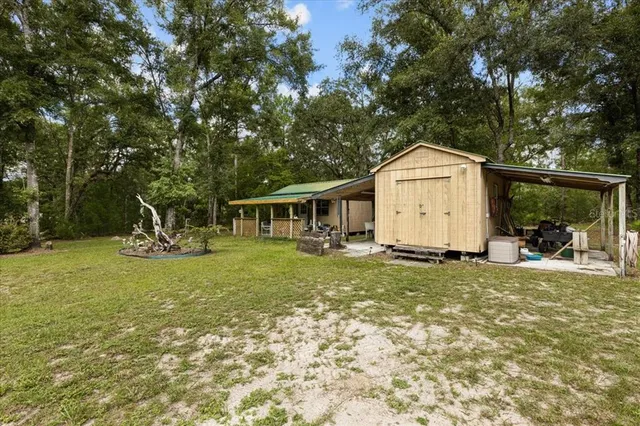 a view of a house with swimming pool and yard with green space