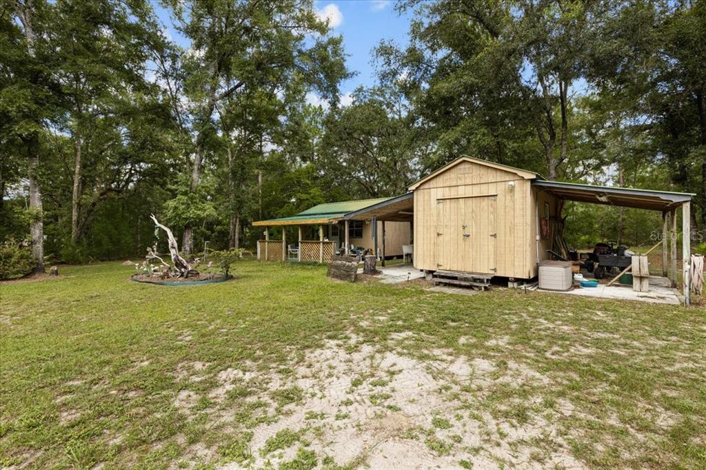 4700 Northwest 55th Avenue Bell, FL 32619 - Photo 45 of 77 a view of a house with backyard and sitting area