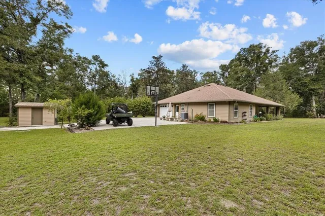 a backyard of a house with large trees