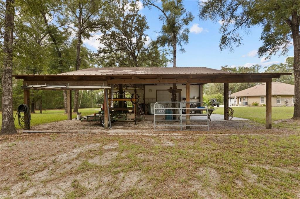 4700 Northwest 55th Avenue Bell, FL 32619 - Photo 50 of 77 a view of a house with backyard porch and sitting area