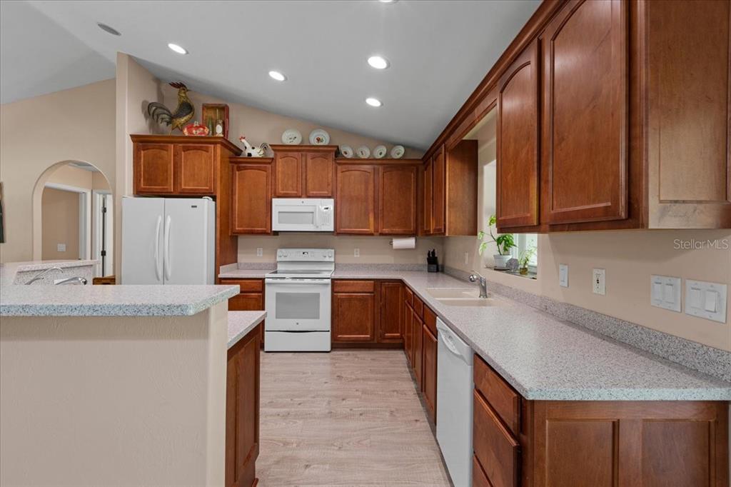 4700 Northwest 55th Avenue Bell, FL 32619 - Photo 5 of 77 a kitchen with granite countertop a sink a counter top space appliances and cabinets