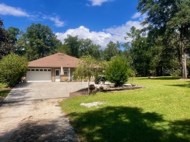 4700 Northwest 55th Avenue Bell, FL 32619 - Photo 67 of 77 a view of a house with swimming pool and yard with green space