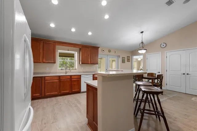 a kitchen with stainless steel appliances granite countertop a sink dishwasher stove and refrigerator