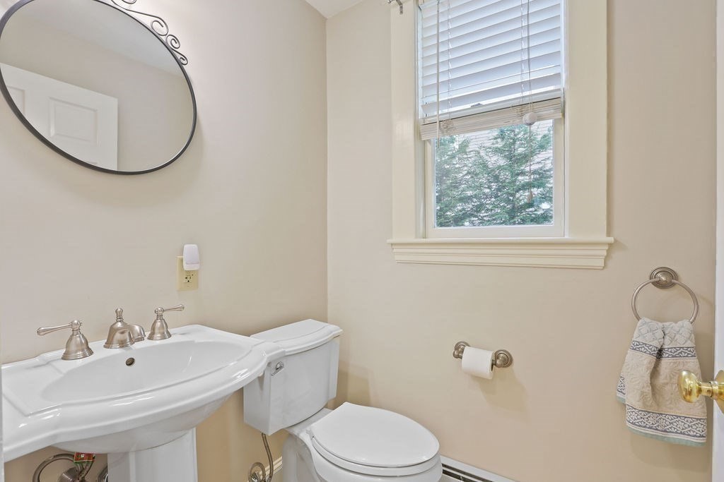 60 Oak Street Needham, MA 02492 - Photo 12 of 23 a bathroom with a sink a toilet and a mirror