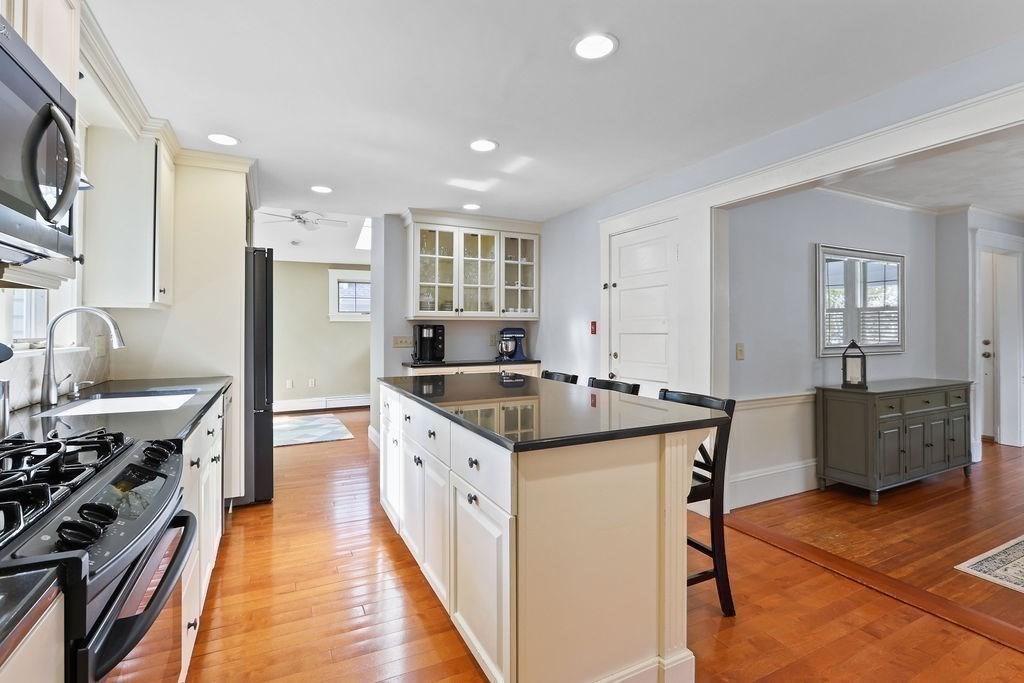 60 Oak Street Needham, MA 02492 - Photo 9 of 23 a kitchen with stainless steel appliances granite countertop a stove and a refrigerator