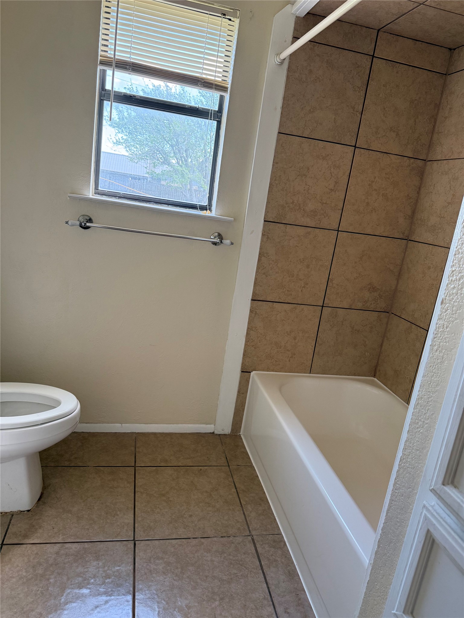 5931 Limmer Loop Hutto, TX 78634 - Photo 14 of 22 Bathroom featuring light tile patterned floors and shower combination