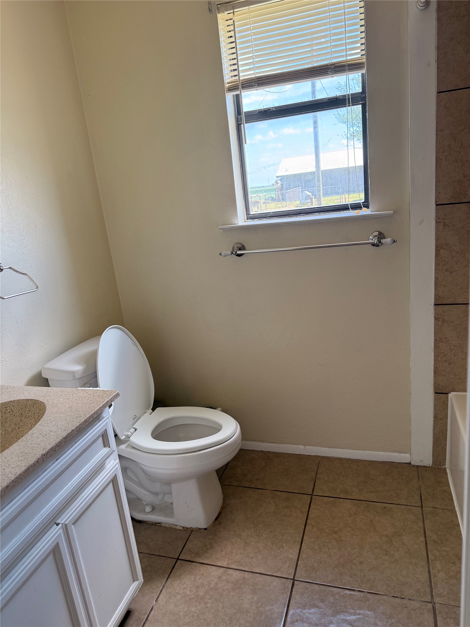 5931 Limmer Loop Hutto, TX 78634 - Photo 15 of 22 Bathroom with vanity, light tile patterned flooring, and a bathtub