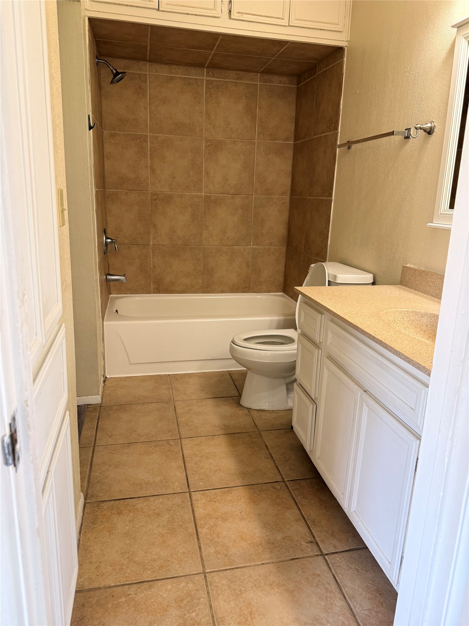 5931 Limmer Loop Hutto, TX 78634 - Photo 18 of 22 Bathroom with vanity, shower / bath combination, and light tile patterned floors