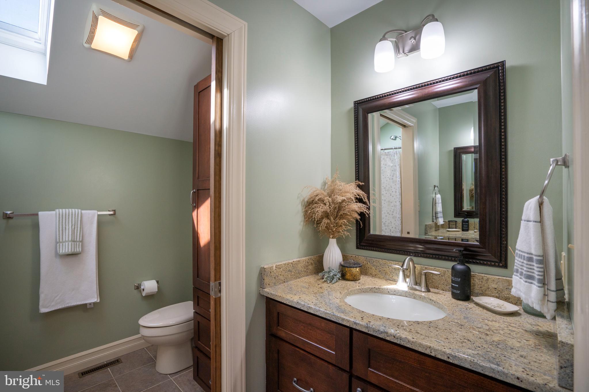 10620 Kyper Road Huntingdon, PA 16652 - Photo 36 of 104 a bathroom with a granite countertop sink toilet and mirror