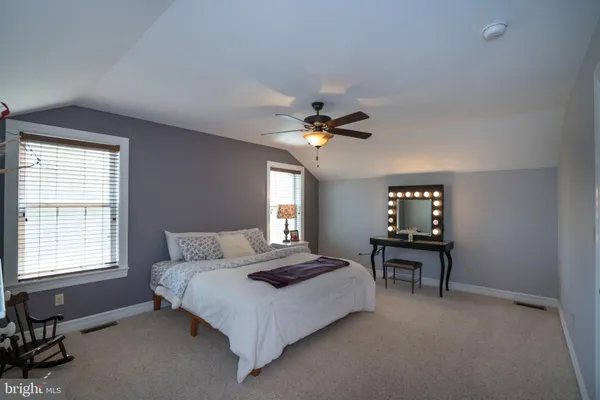a living room with furniture and large windows