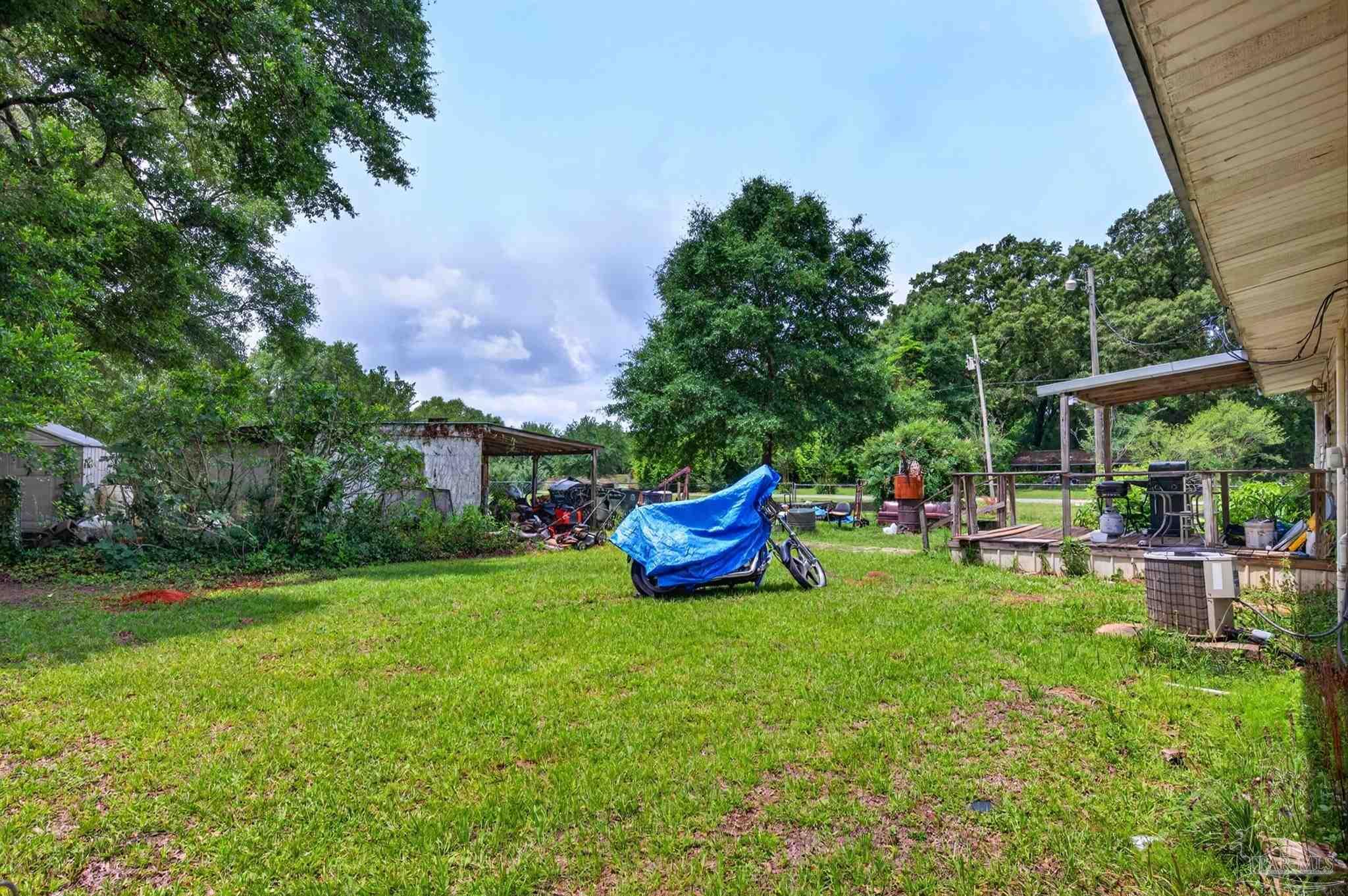 6253 Allentown Road Milton, FL 32570 - Photo 27 of 31 a view of a chair and table on the garden