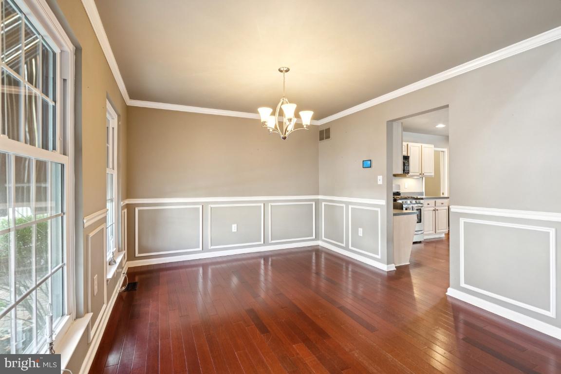 121 Weathervane Drive Mount Royal, NJ 08061 - Photo 5 of 31 a view of a hallway with wooden floor and chandelier