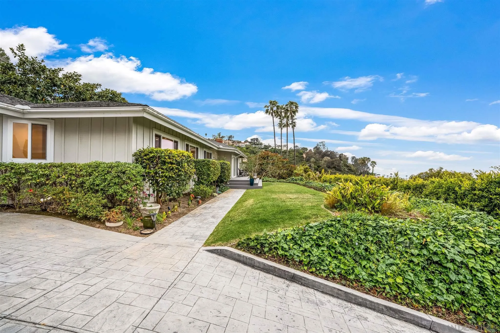 7356 Rue Michael La Jolla, CA 92037 - Photo 16 of 48 a front view of a house with garden