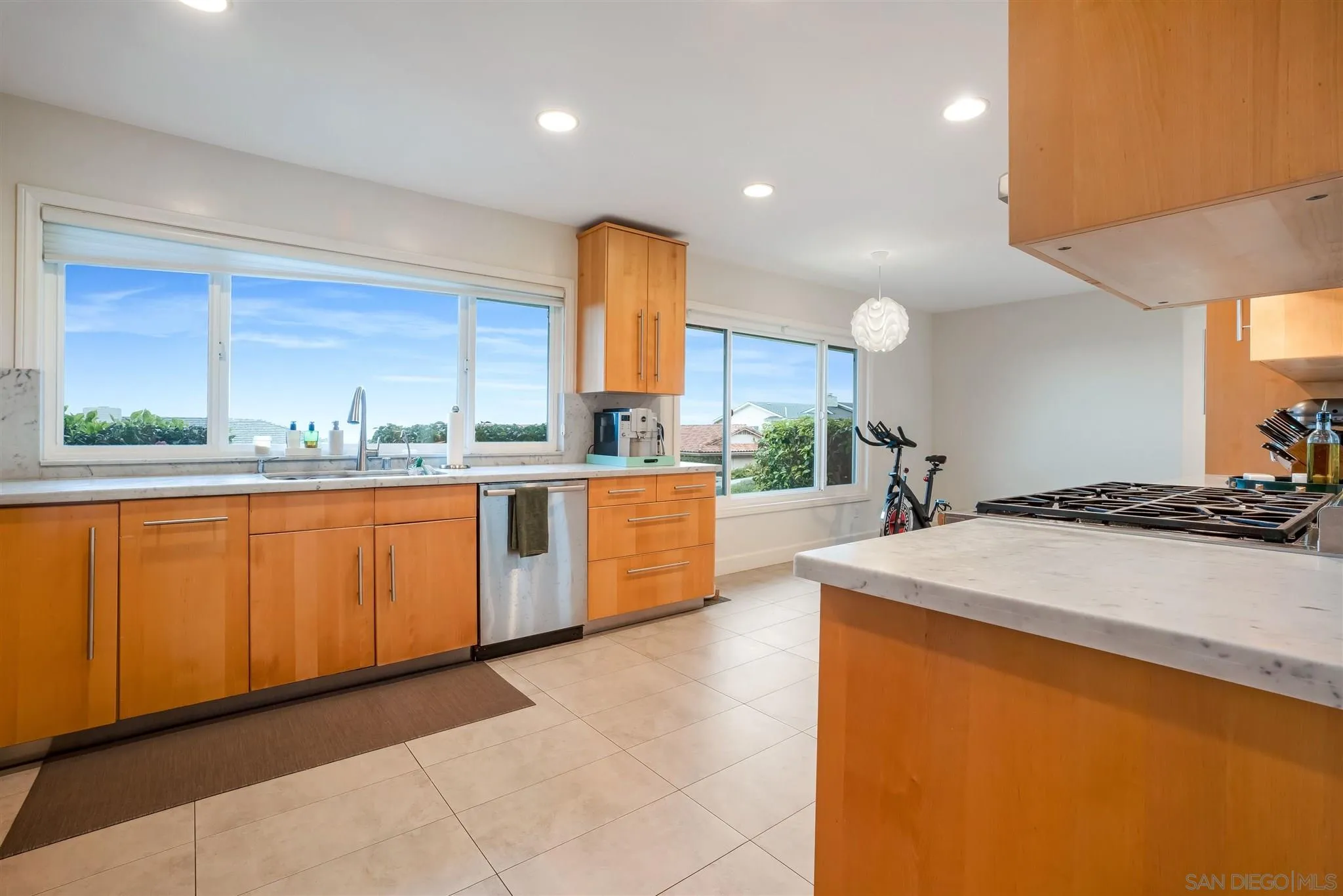 7356 Rue Michael La Jolla, CA 92037 - Photo 21 of 48 a kitchen with stainless steel appliances a sink counter space and a large window