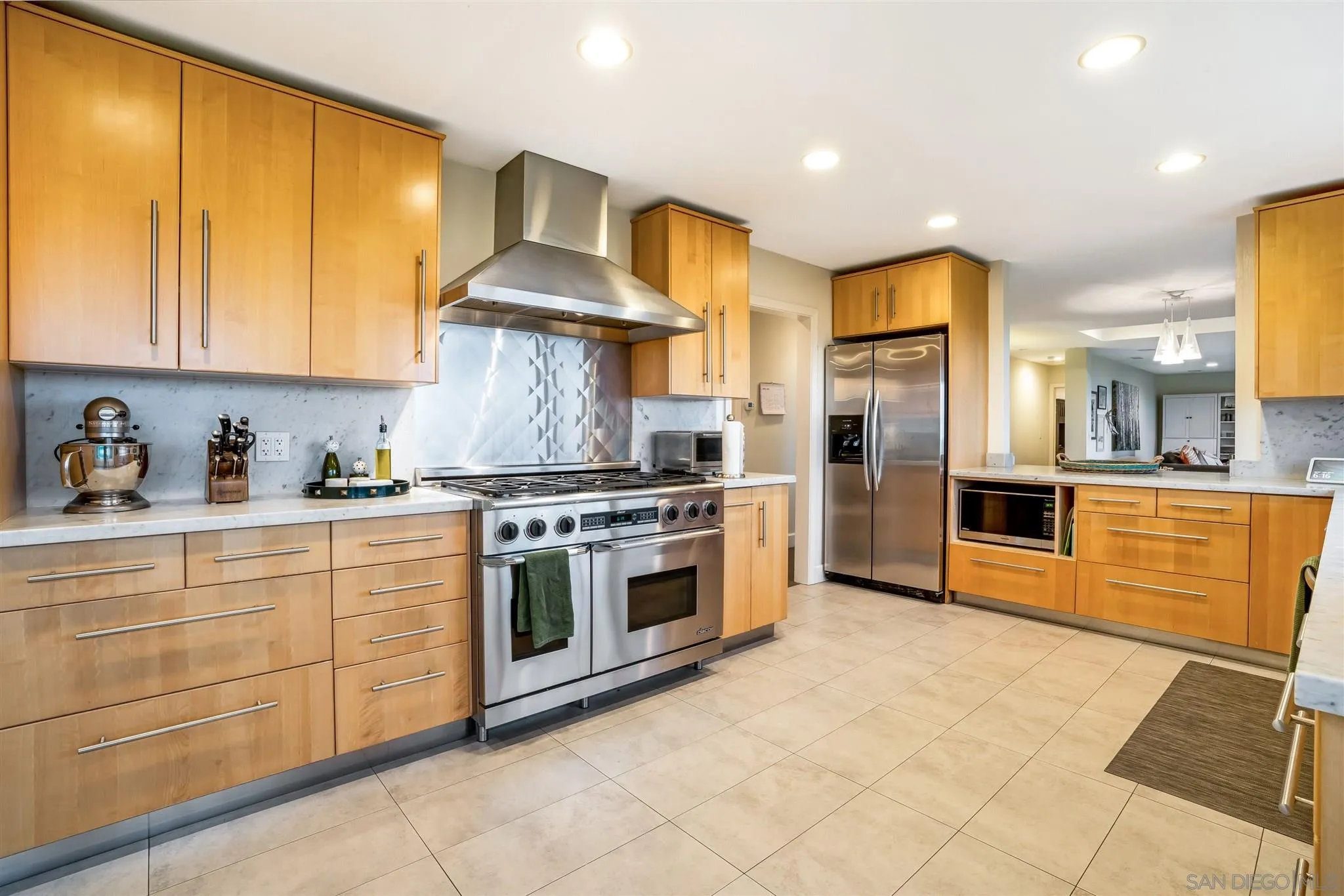 7356 Rue Michael La Jolla, CA 92037 - Photo 31 of 48 a kitchen with stainless steel appliances granite countertop a stove a sink and a refrigerator