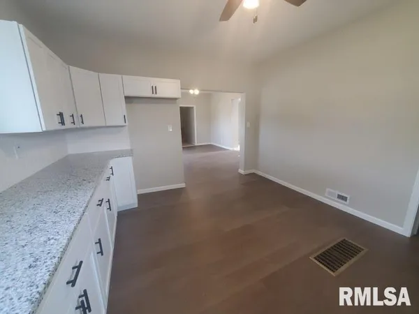 a view of a kitchen with a sink and cabinets