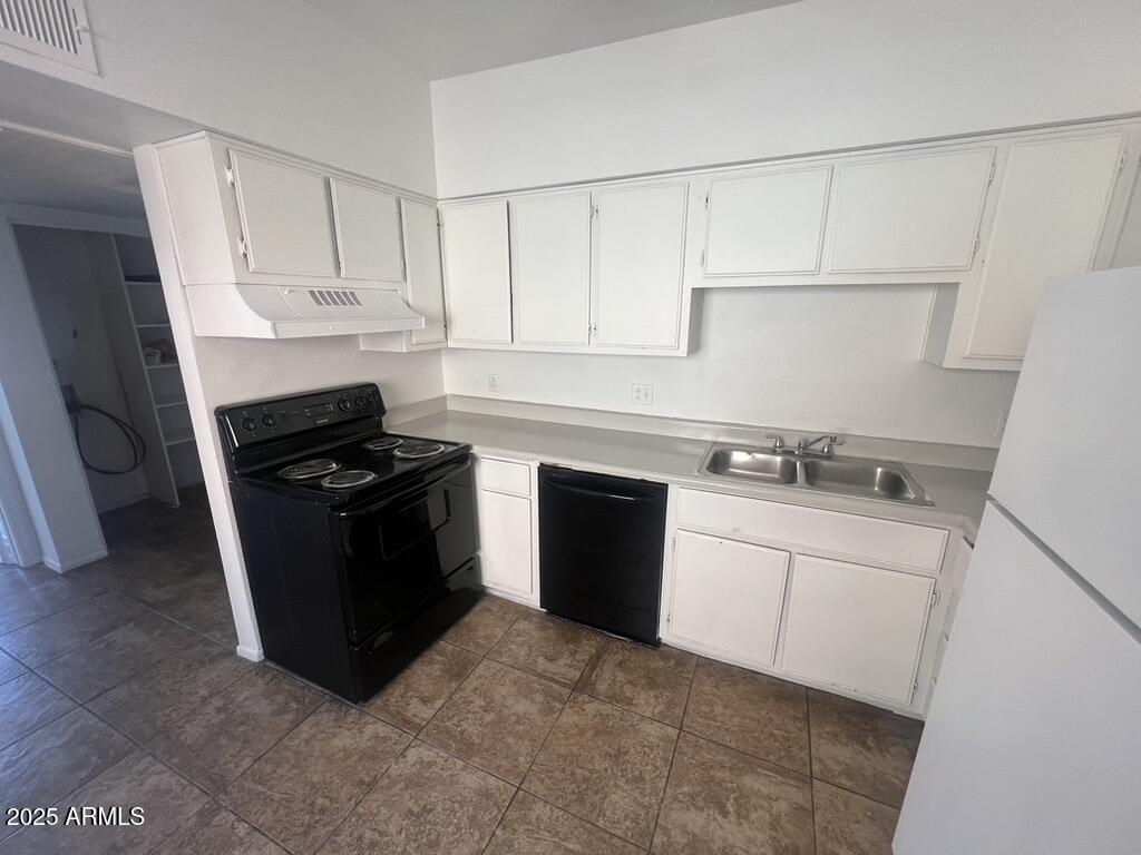 2838 East Marconi Avenue, Unit 203 Phoenix, AZ 85032 - Photo 11 of 22 a kitchen with white cabinets and black appliances