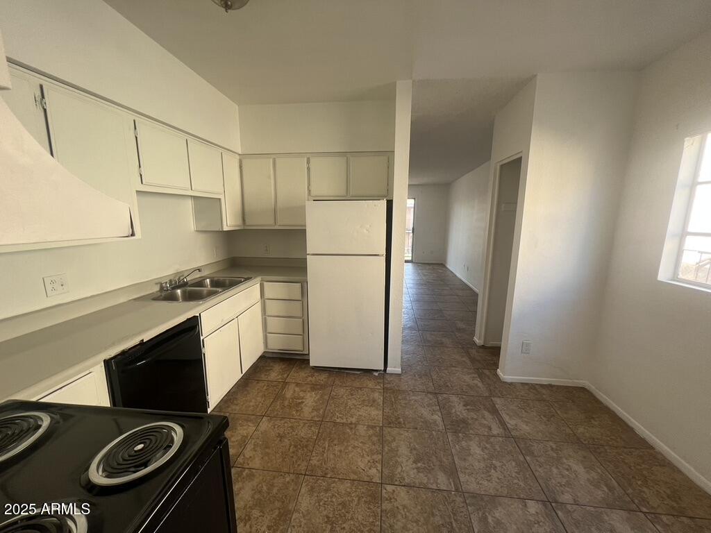 2838 East Marconi Avenue, Unit 203 Phoenix, AZ 85032 - Photo 12 of 22 a kitchen with a refrigerator stove and cabinets