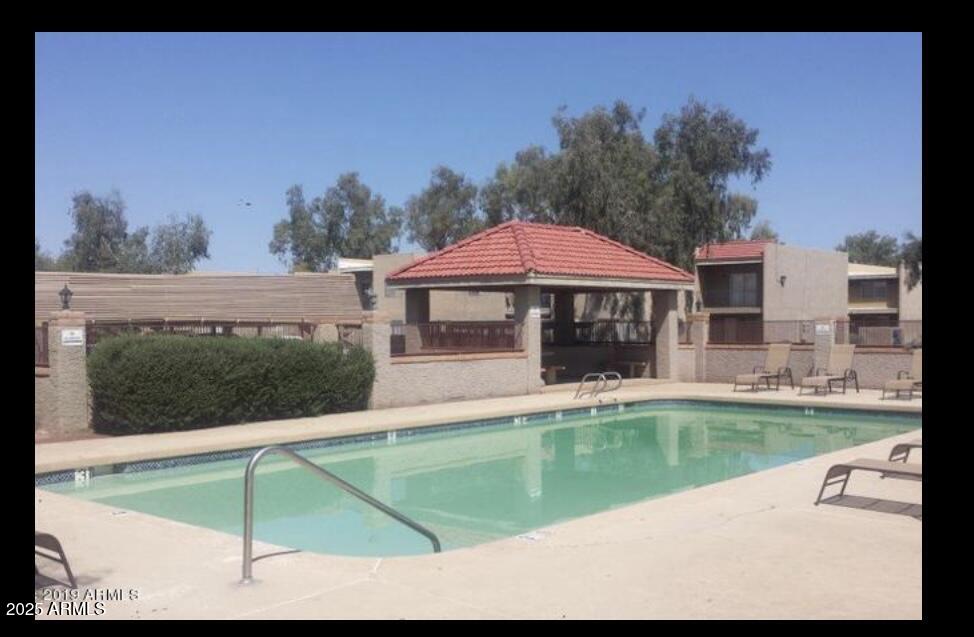 2838 East Marconi Avenue, Unit 203 Phoenix, AZ 85032 - Photo 4 of 22 a view of a house with a swimming pool