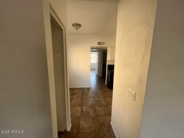 a kitchen with white cabinets and black appliances