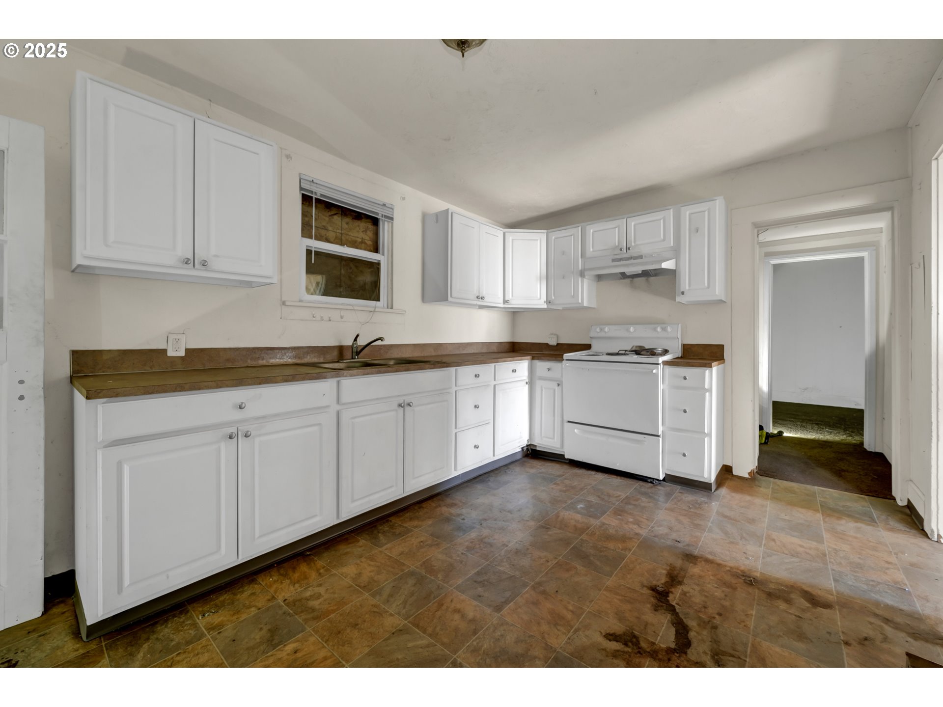 168 North Cleveland Street Eugene, OR 97402 - Photo 11 of 40 a kitchen with white cabinets a sink and dishwasher