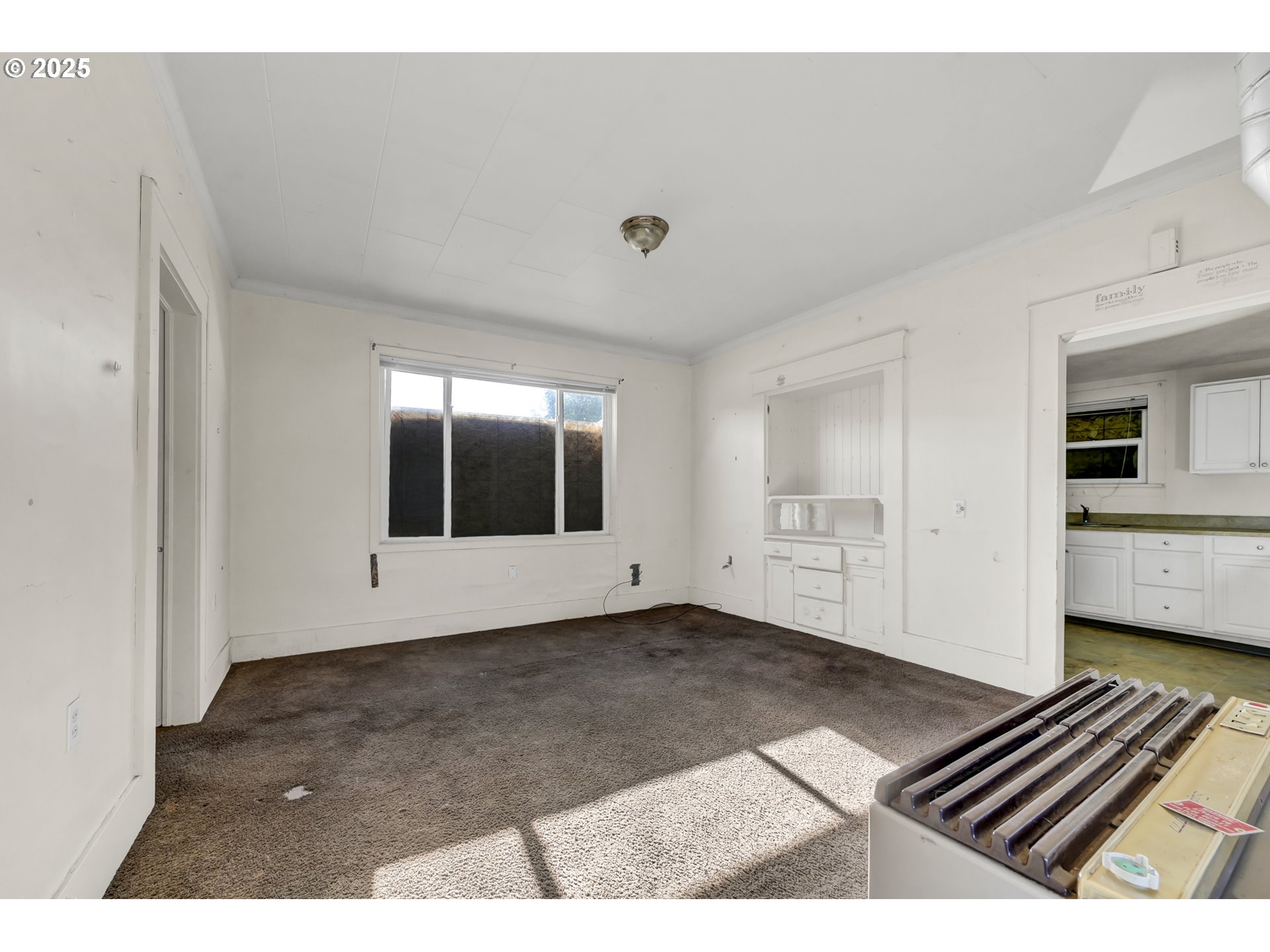 168 North Cleveland Street Eugene, OR 97402 - Photo 5 of 40 a view of an empty room with wooden floor and a window
