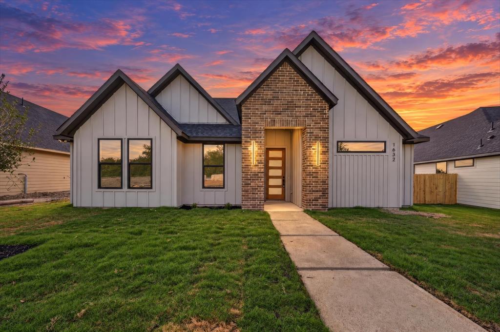 1632 West Wintergreen Road Lancaster, TX 75134 - Photo 1 of 30 Modern farmhouse-style exterior featuring vertical white siding and dark trim