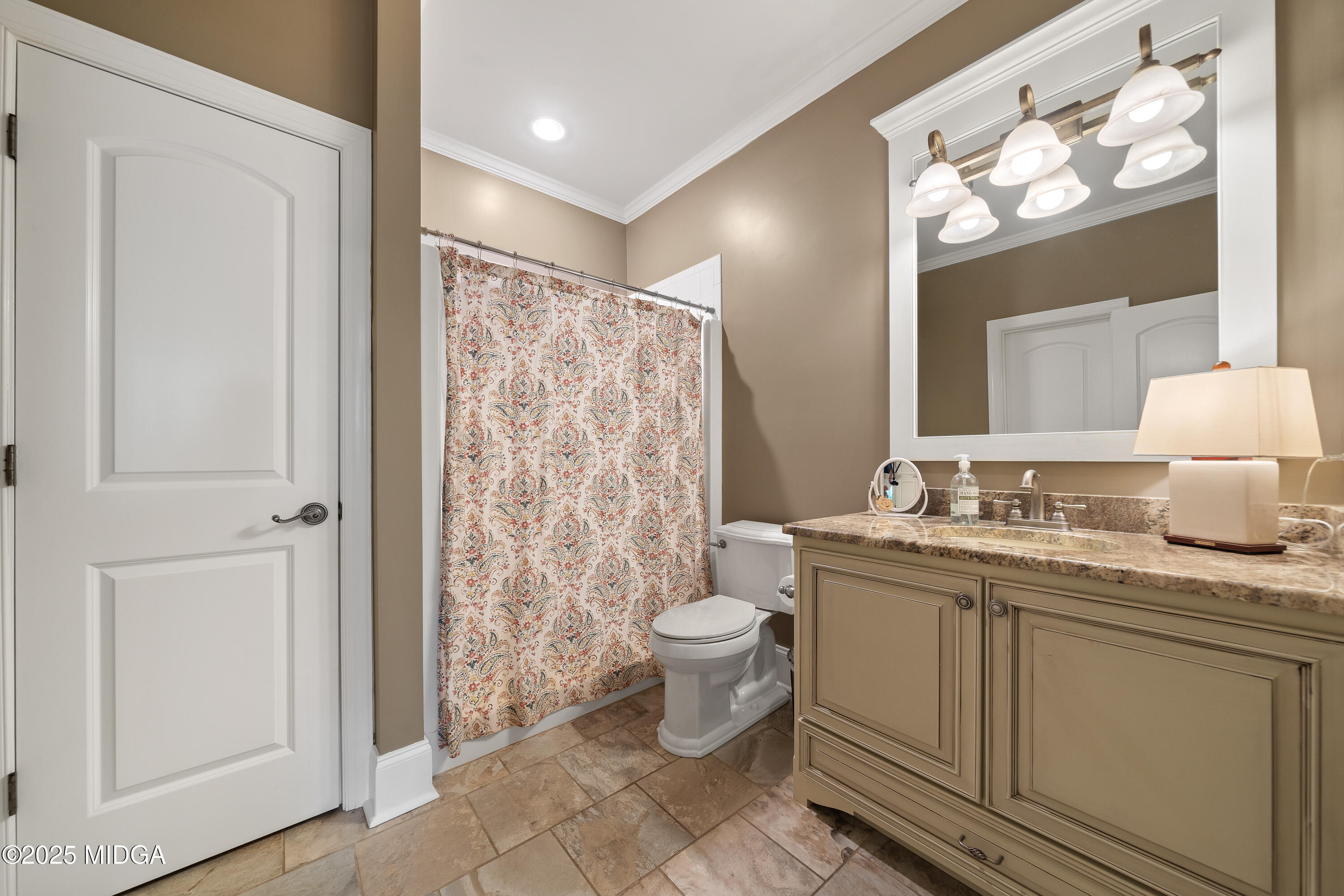415 Irongate Macon, GA 31220 - Photo 40 of 56 a bathroom with a granite countertop sink a toilet a mirror a vanity and shower
