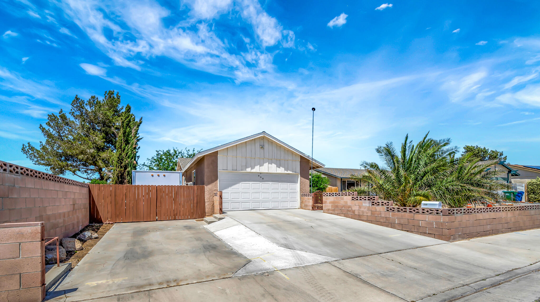 209 North Sunland Drive Ridgecrest, CA 93555 - Photo 1 of 51 a front view of a house with a yard and garage