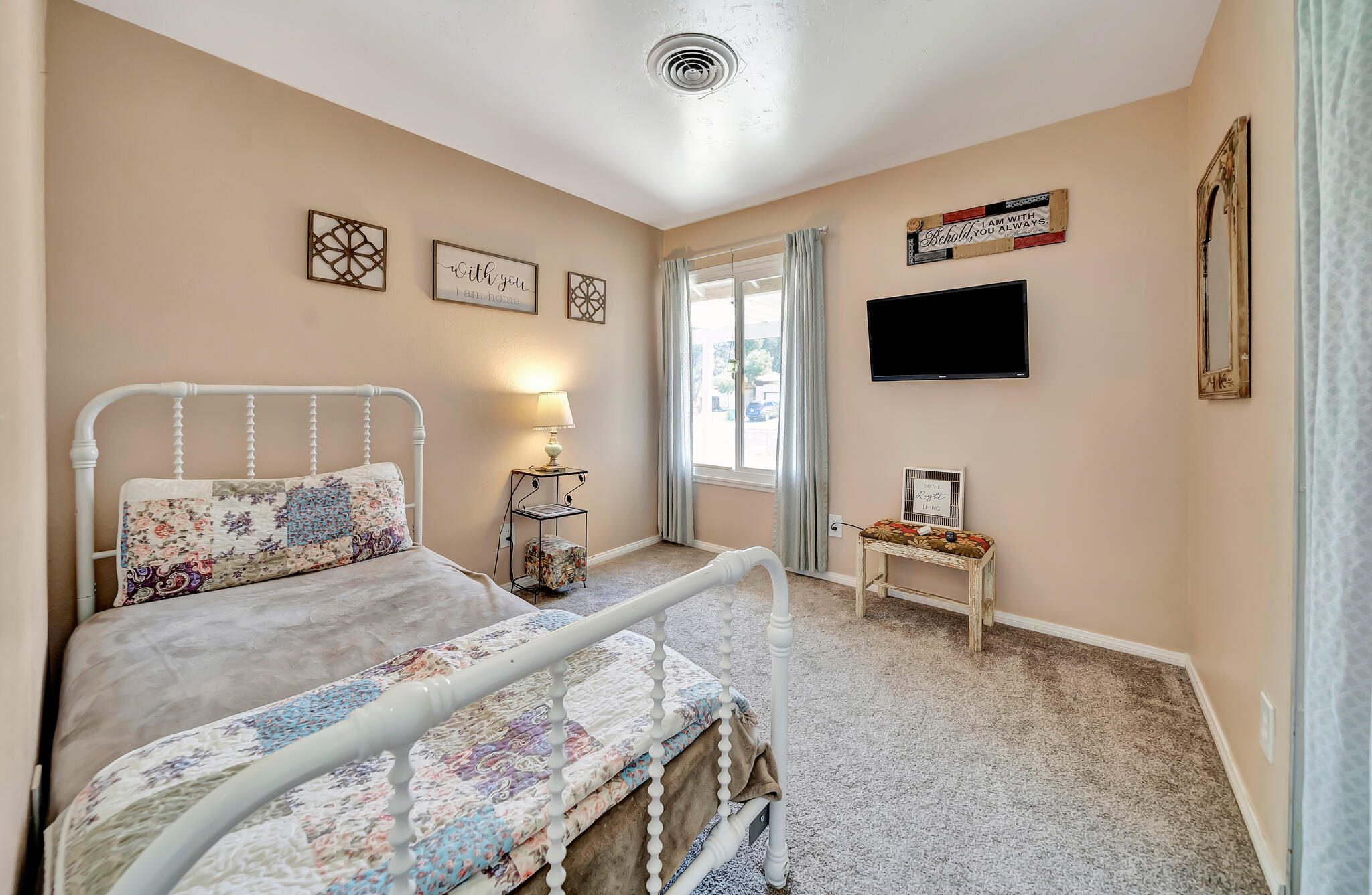 209 North Sunland Drive Ridgecrest, CA 93555 - Photo 15 of 51 a bedroom with a bed and a flat screen tv