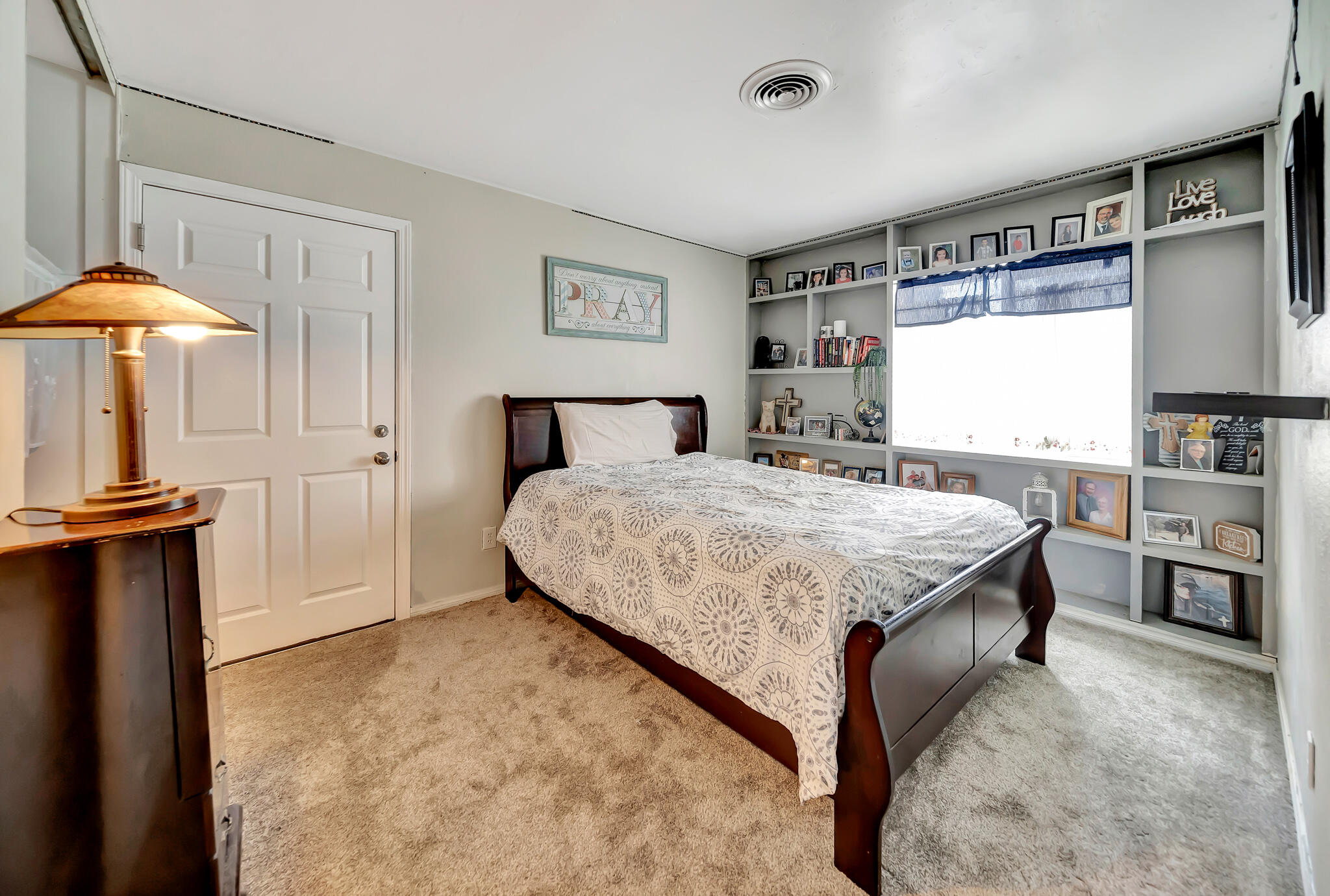 209 North Sunland Drive Ridgecrest, CA 93555 - Photo 18 of 51 a bedroom with a bed and dresser with wooden floor