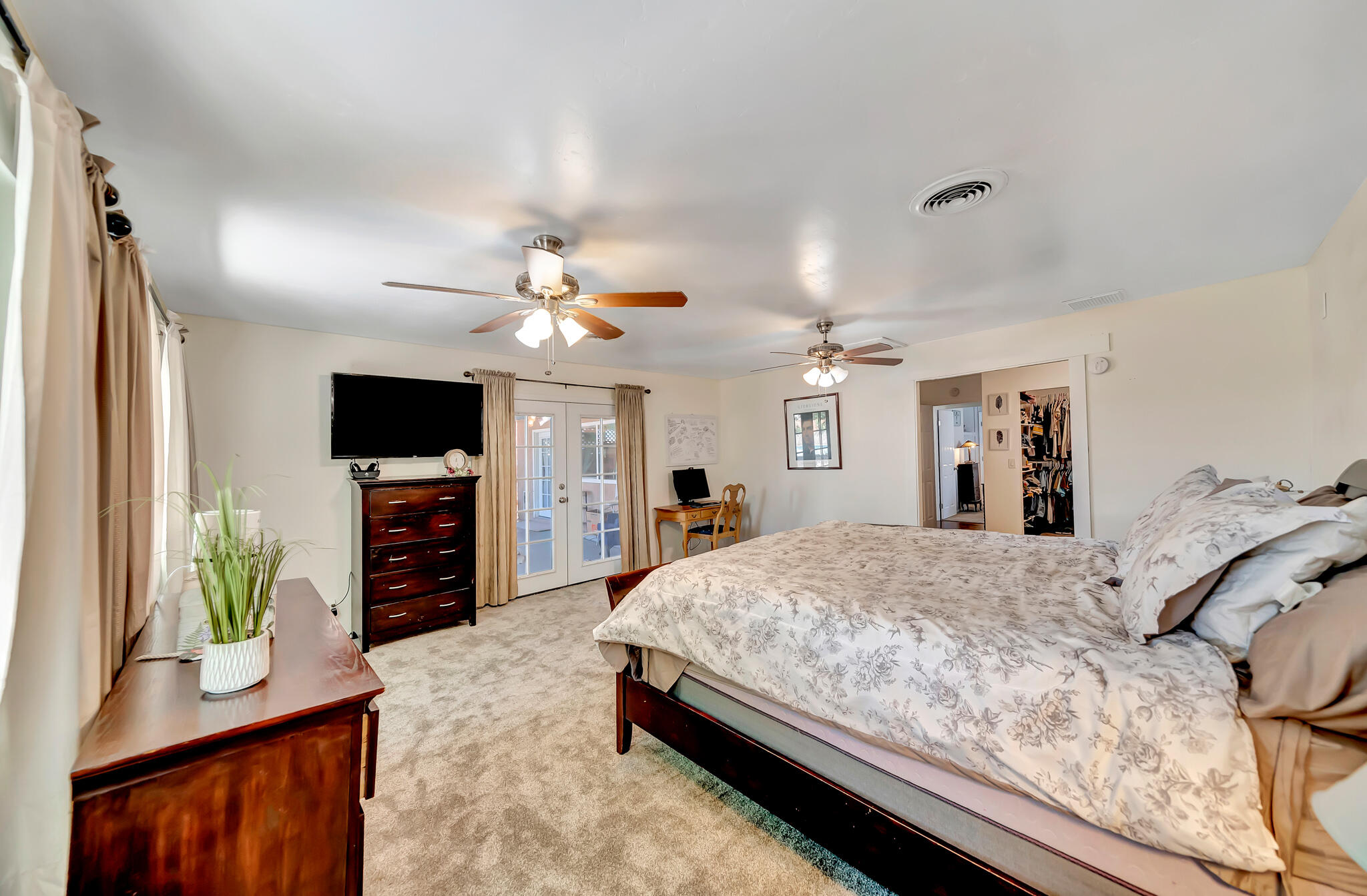 209 North Sunland Drive Ridgecrest, CA 93555 - Photo 32 of 51 a bedroom with a bed window and a flat screen television