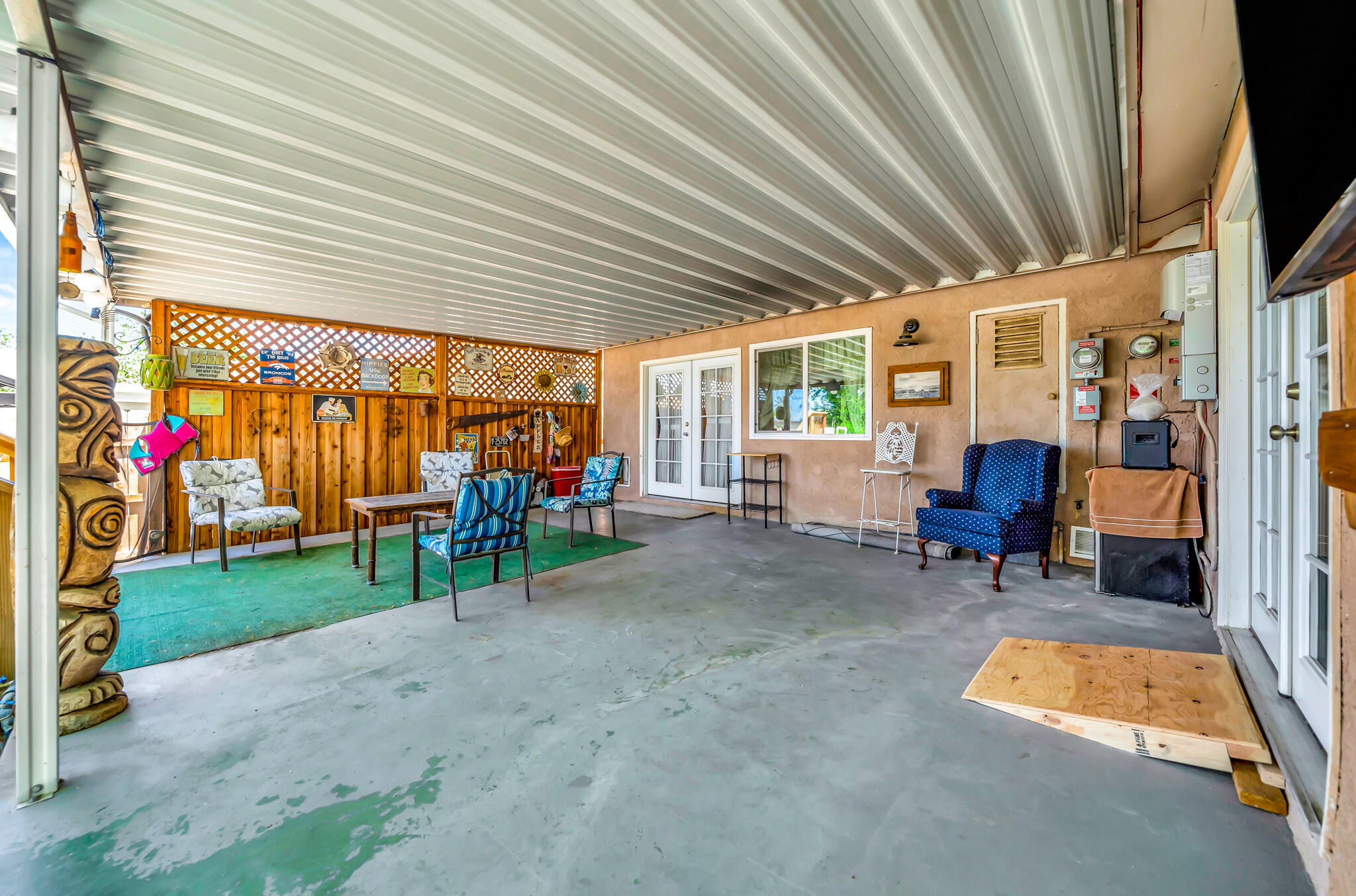 209 North Sunland Drive Ridgecrest, CA 93555 - Photo 34 of 51 a view of a patio with table and chairs and a barbeque grill with floor to ceiling window