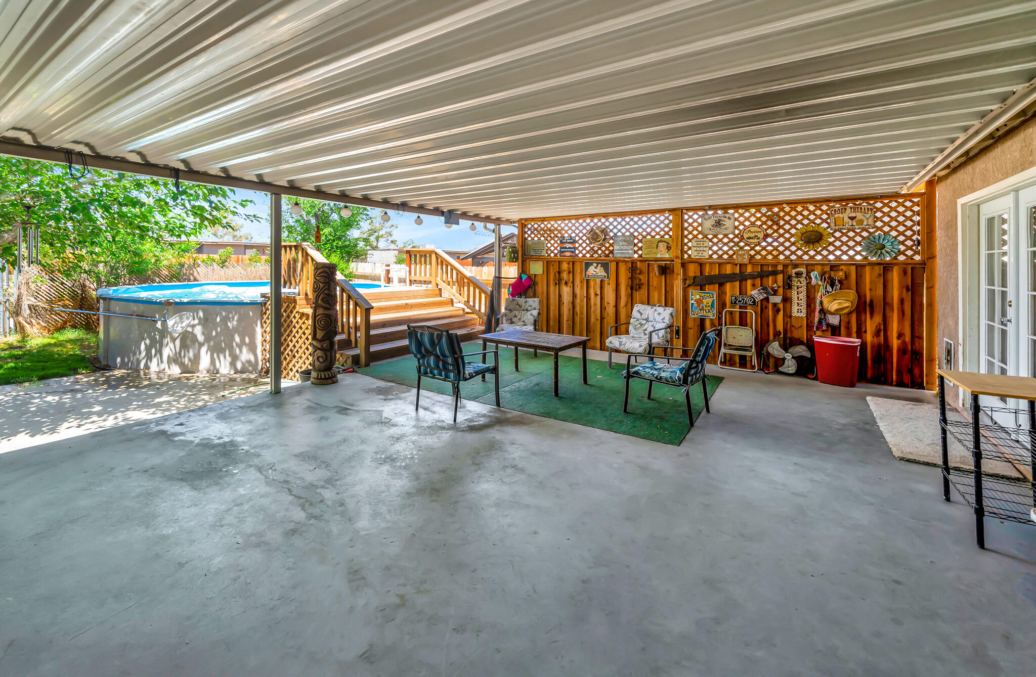 209 North Sunland Drive Ridgecrest, CA 93555 - Photo 35 of 51 an outdoor sitting area with a tree