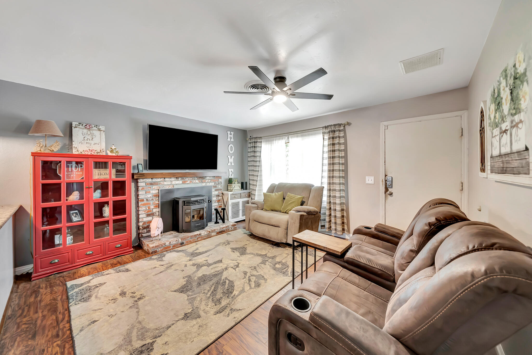 209 North Sunland Drive Ridgecrest, CA 93555 - Photo 4 of 51 a living room with furniture a fireplace and a flat screen tv