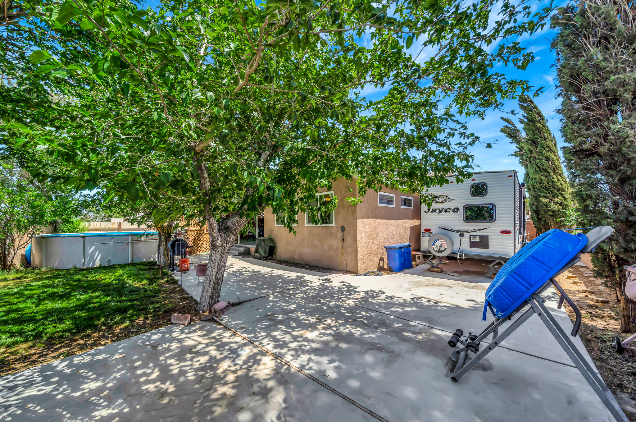 209 North Sunland Drive Ridgecrest, CA 93555 - Photo 41 of 51 a view of a patio with a table and chairs under an umbrella