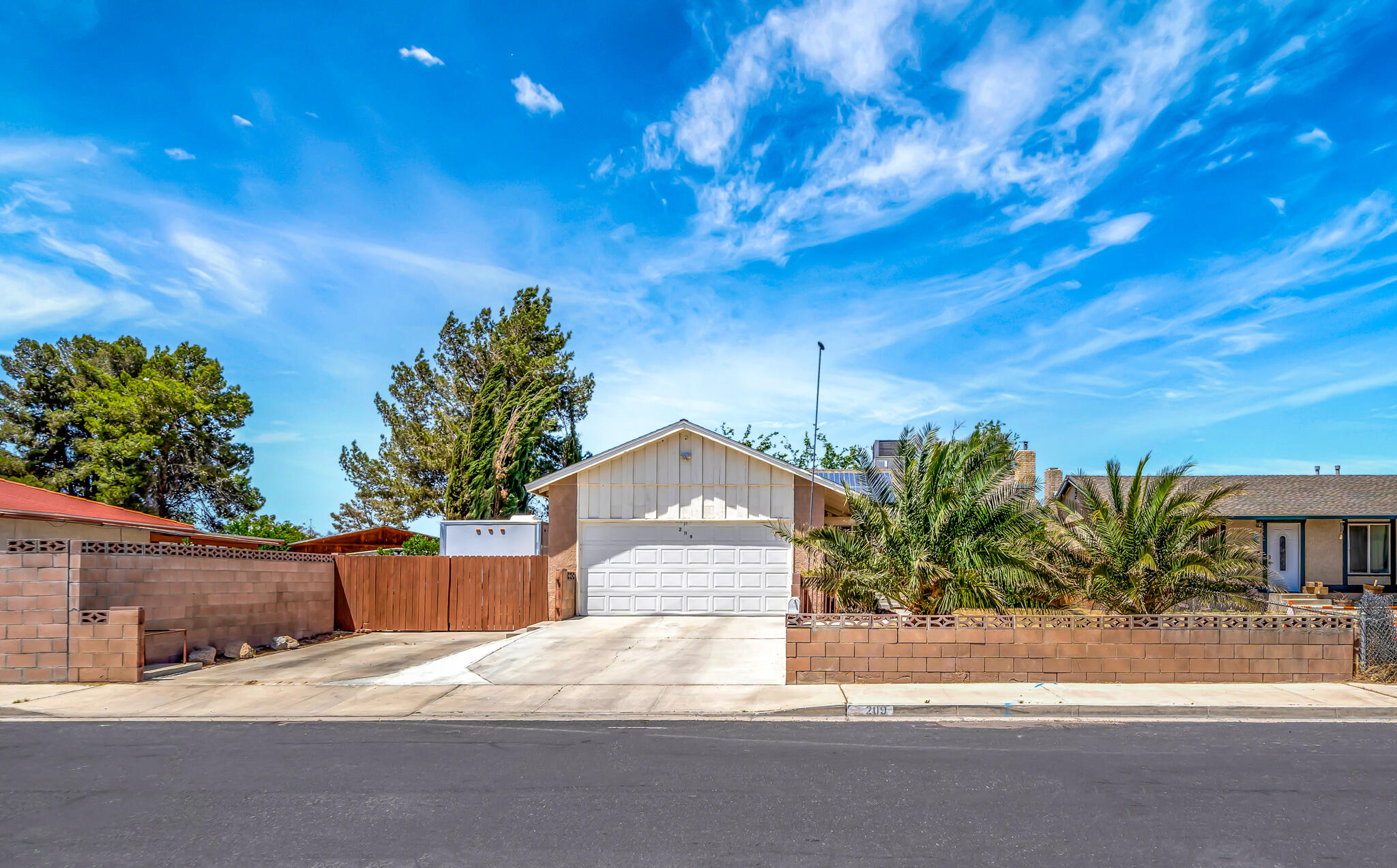 209 North Sunland Drive Ridgecrest, CA 93555 - Photo 48 of 51 a house with a tree in front of it