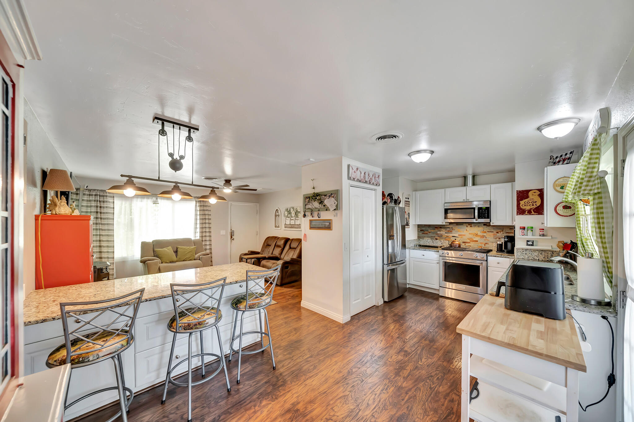 209 North Sunland Drive Ridgecrest, CA 93555 - Photo 8 of 51 a living room with stainless steel appliances kitchen island granite countertop furniture and a kitchen view