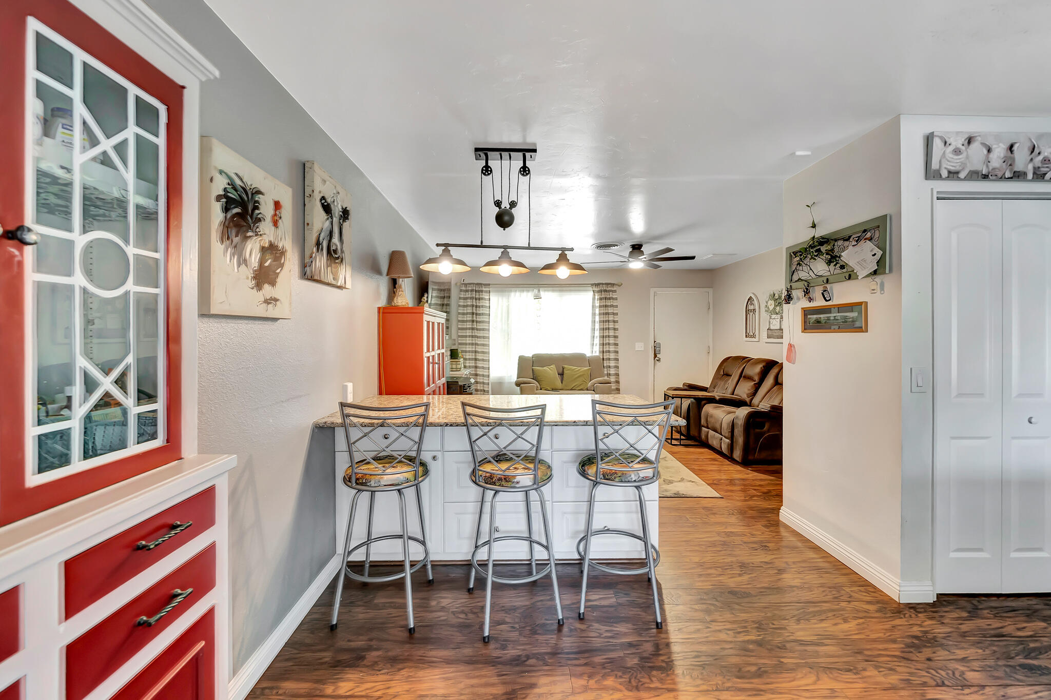 209 North Sunland Drive Ridgecrest, CA 93555 - Photo 9 of 51 a view of a dining room with furniture a chandelier and wooden floor