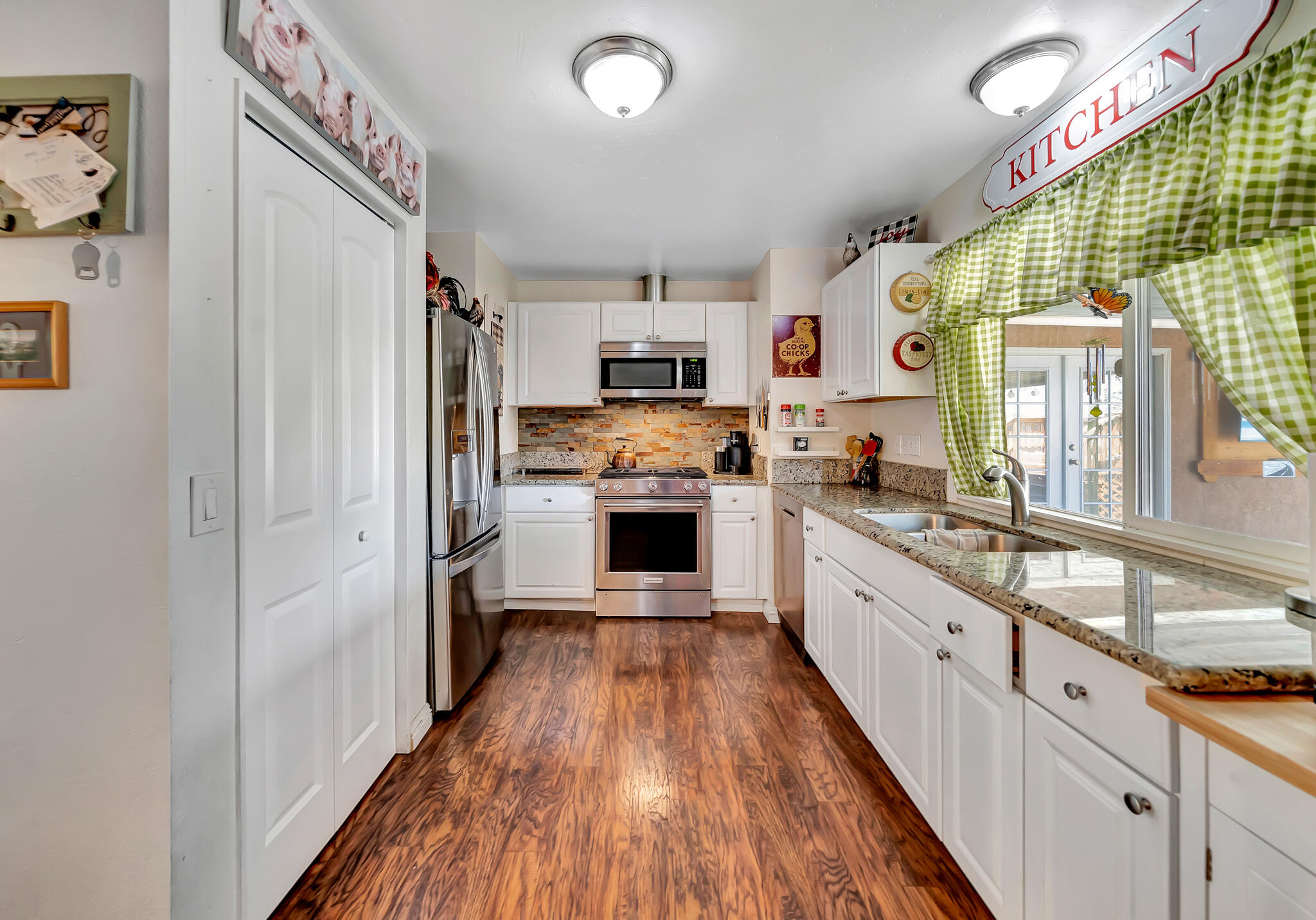 209 North Sunland Drive Ridgecrest, CA 93555 - Photo 10 of 51 a large kitchen with granite countertop a large counter top a sink stainless steel appliances and cabinets