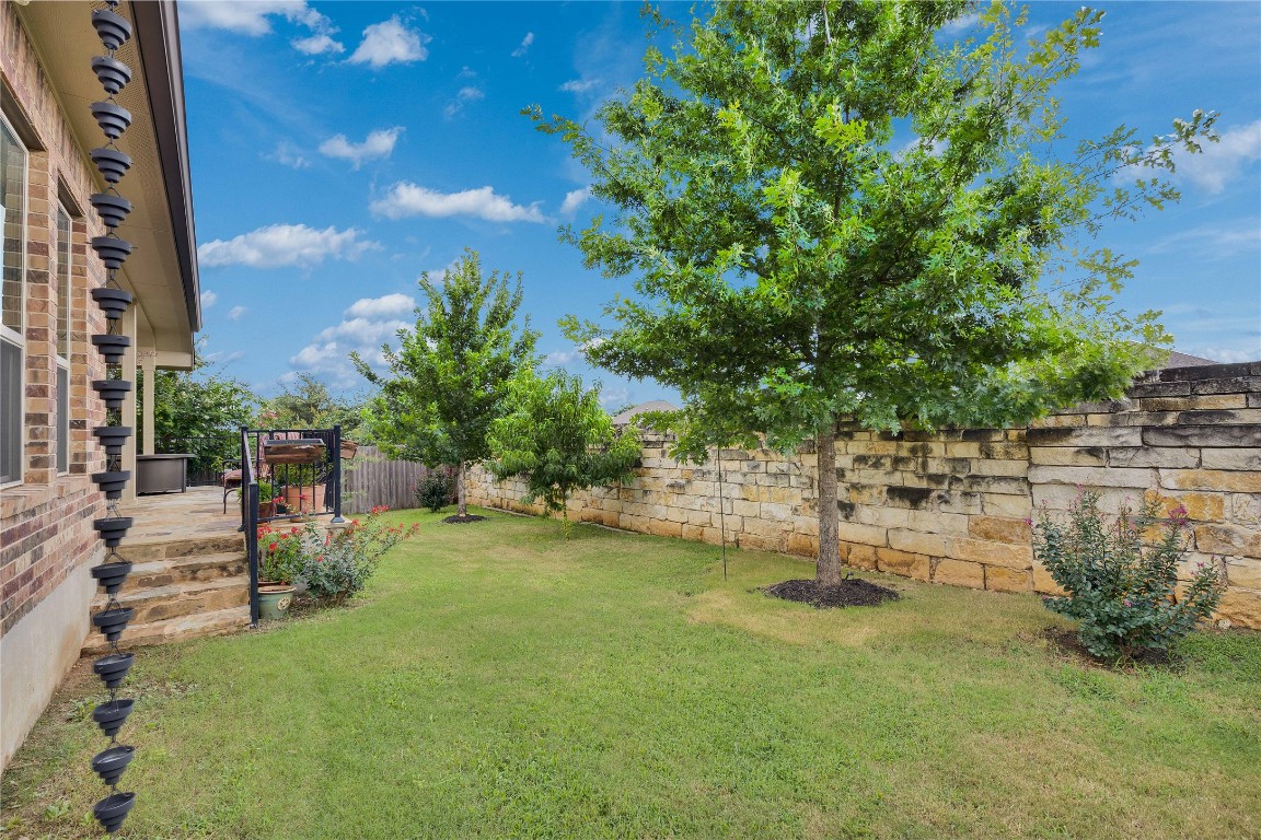 1312 Terrace View Drive Georgetown, TX 78628 - Photo 14 of 40 a view of a lake with a bench and trees in the background