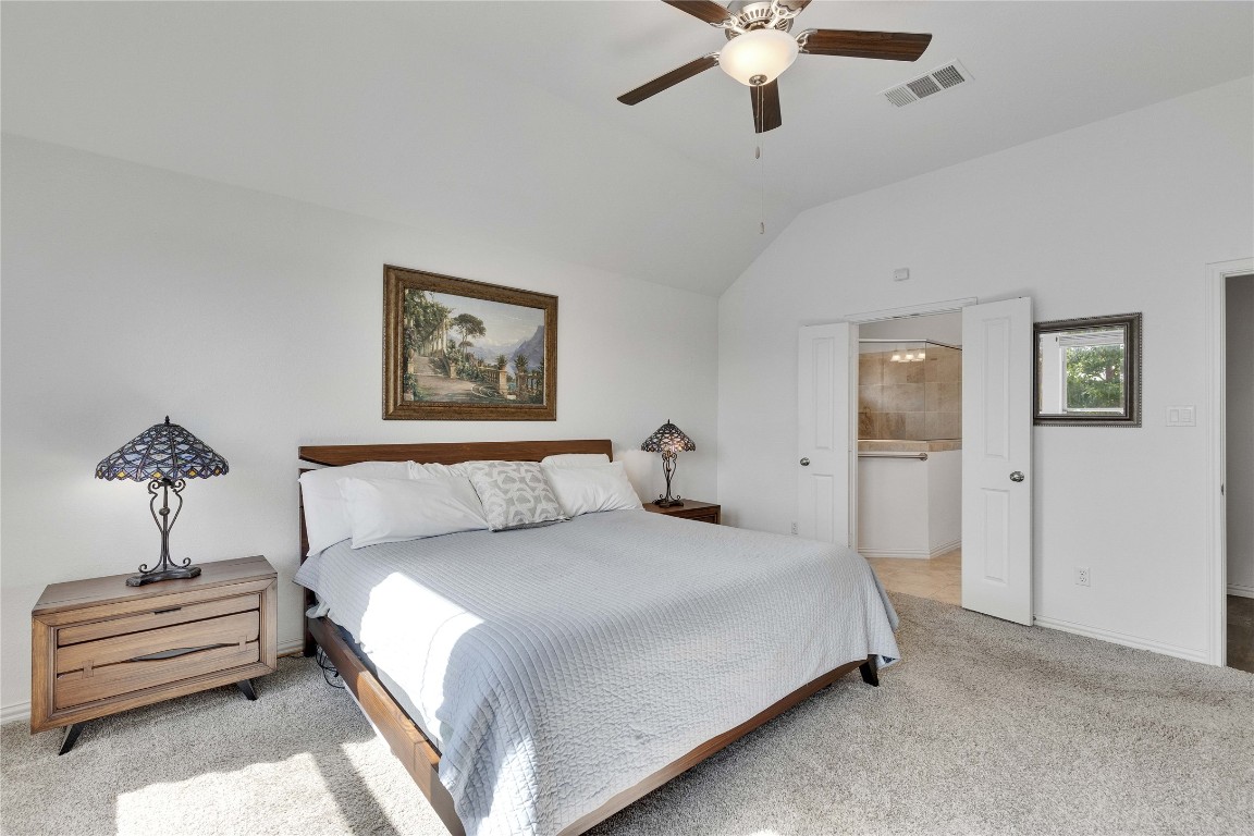 1312 Terrace View Drive Georgetown, TX 78628 - Photo 20 of 40 a bedroom with a bed and a chandelier