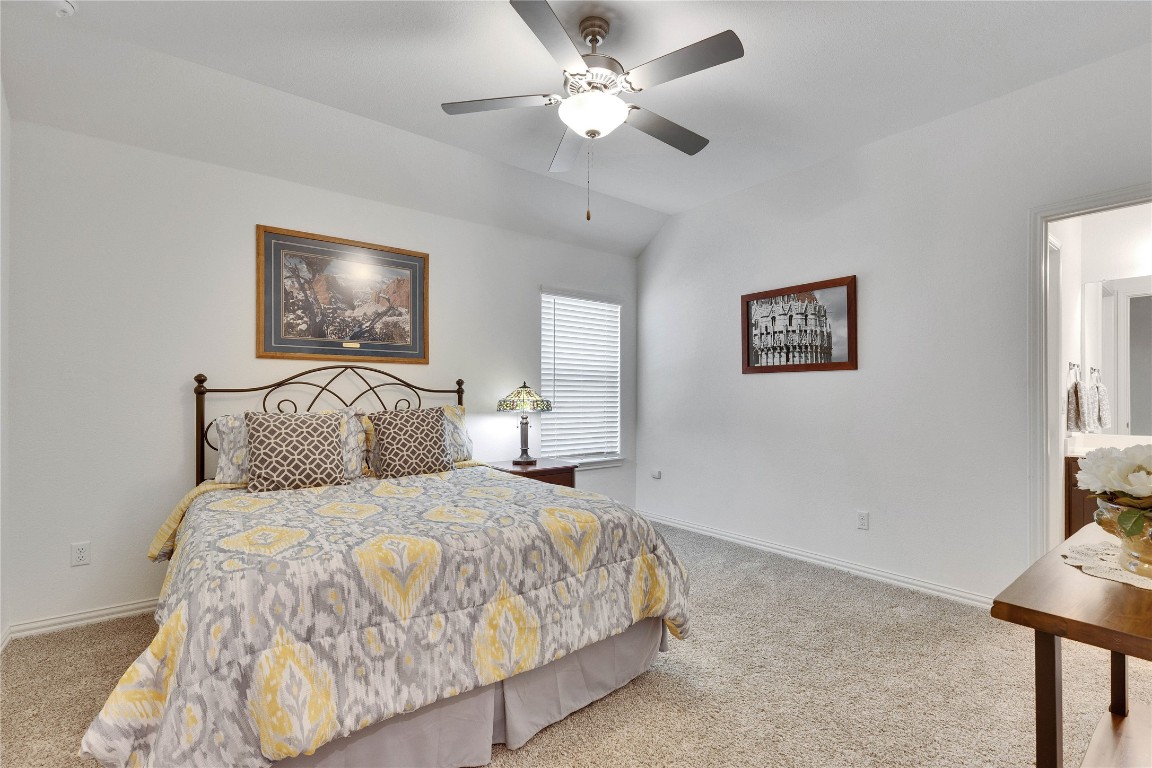 1312 Terrace View Drive Georgetown, TX 78628 - Photo 24 of 40 a bedroom with bed and a chandelier