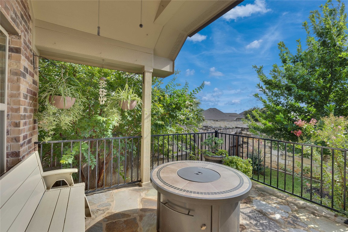 1312 Terrace View Drive Georgetown, TX 78628 - Photo 26 of 40 a view of a patio with a table chairs and iron fence