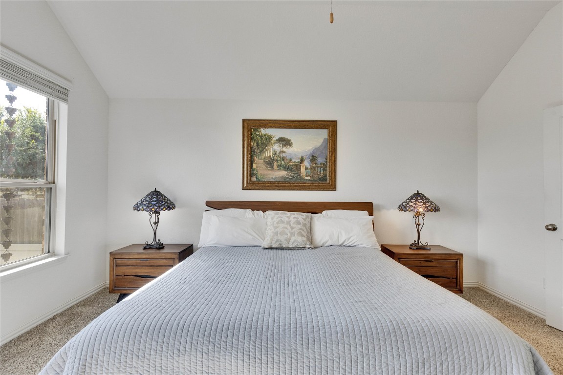 1312 Terrace View Drive Georgetown, TX 78628 - Photo 31 of 40 a bedroom with a bed and a chandelier