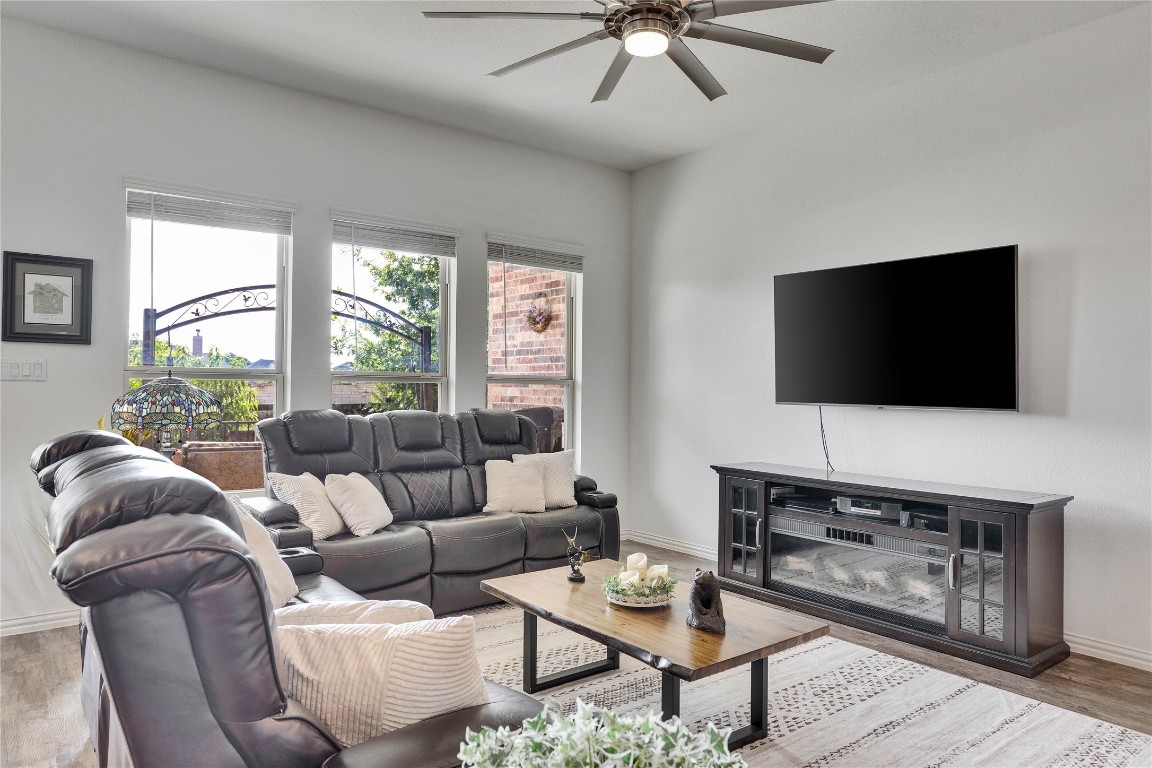 1312 Terrace View Drive Georgetown, TX 78628 - Photo 34 of 40 a living room with furniture a flat screen tv and a floor to ceiling window