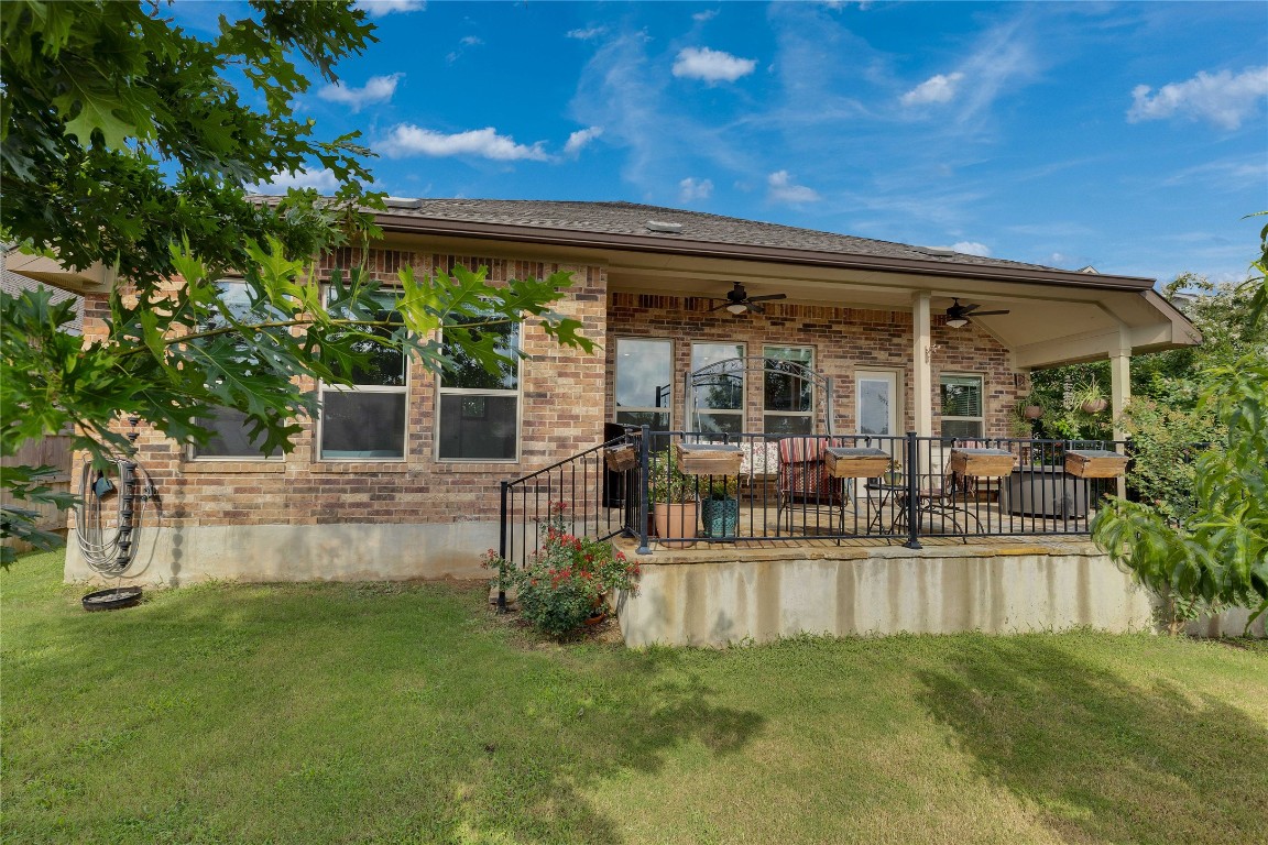 1312 Terrace View Drive Georgetown, TX 78628 - Photo 38 of 40 Backyard and patio with brick siding, a ceiling fan, and a privacy fenced backyard.