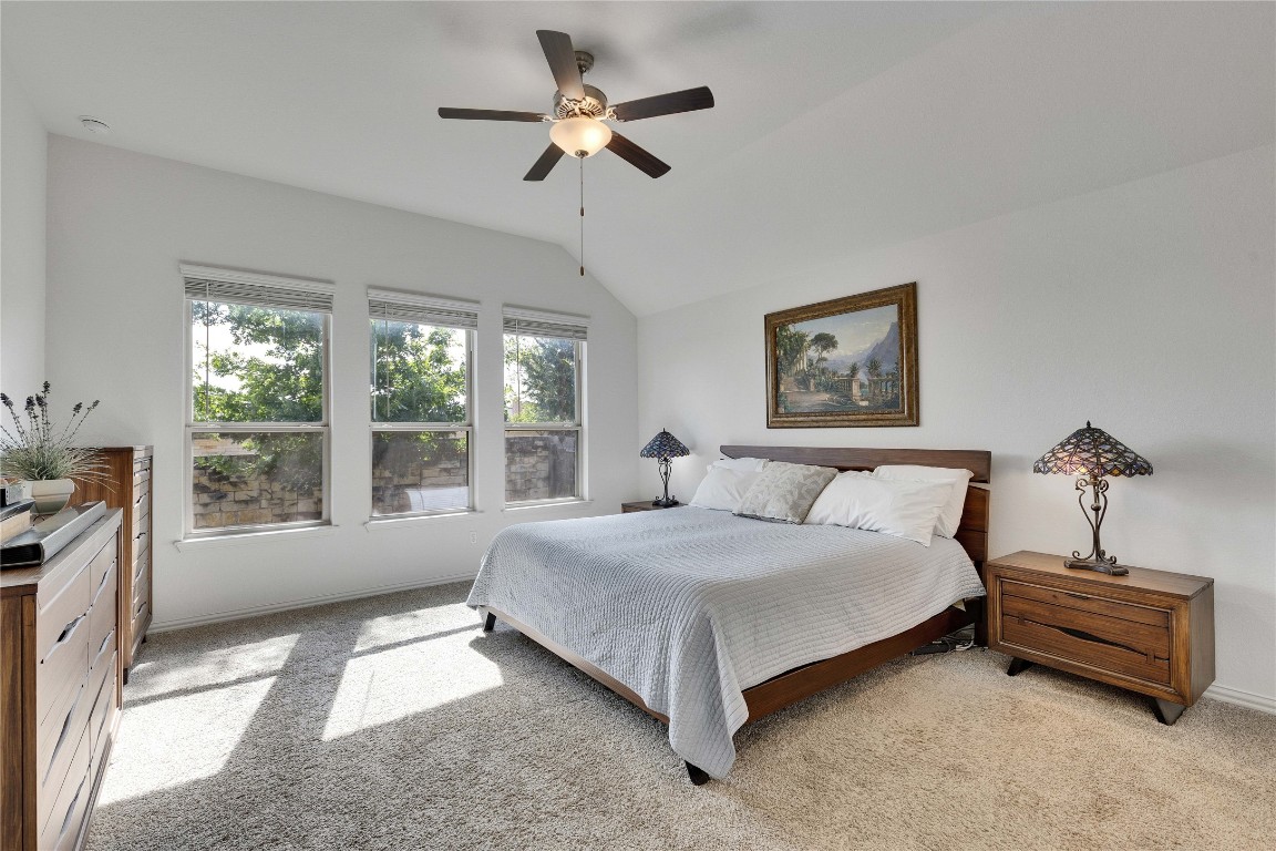 1312 Terrace View Drive Georgetown, TX 78628 - Photo 5 of 40 a spacious bedroom with a bed a large window and a chandelier