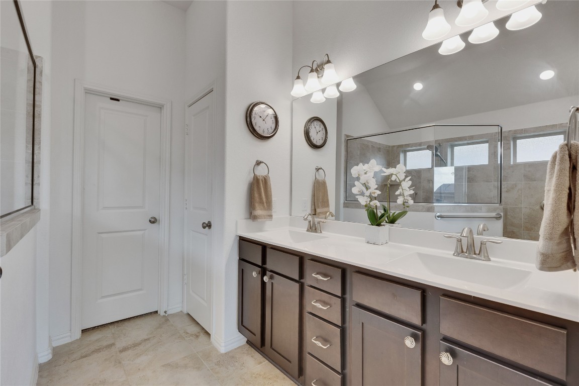 1312 Terrace View Drive Georgetown, TX 78628 - Photo 7 of 40 Full bathroom with double vanity, tiled walk in shower, and lofted ceiling.