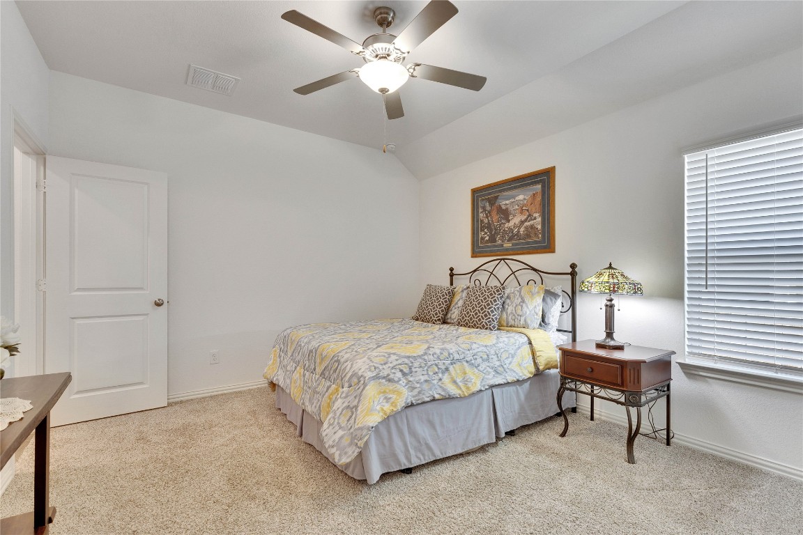 1312 Terrace View Drive Georgetown, TX 78628 - Photo 10 of 40 a bedroom with a bed and a chandelier
